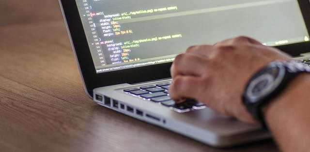 Developers collaborating at a laptop